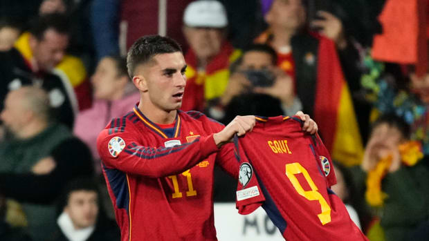 Ferran Torres pictured holding up the jersey of Spain teammate Gavi after scoring in a 3-1 win over Georgia in November 2023
